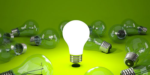Light bulb on green background